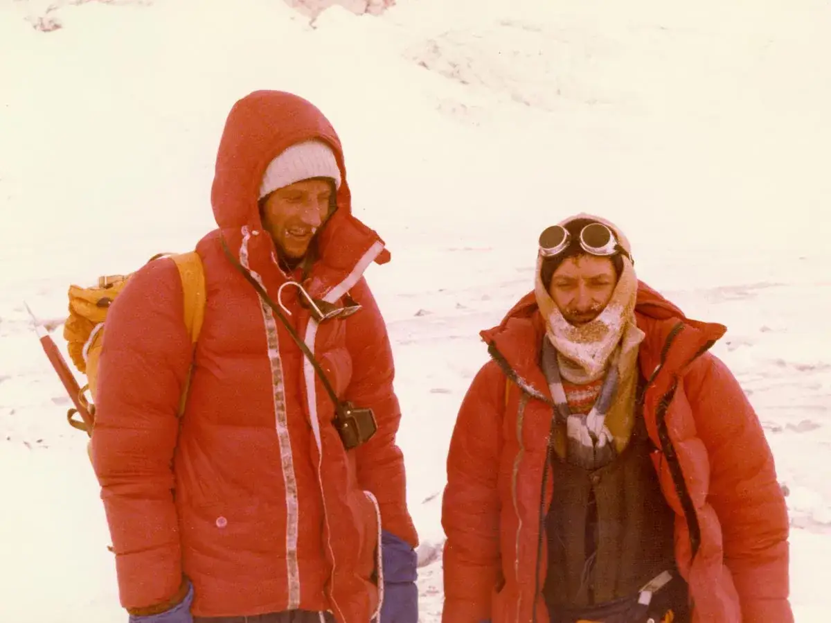 Dwóch Polaków na Mount Everest w czerwonych kurtkach puchowych, w czapkach i goglach, gotowych na zimno.